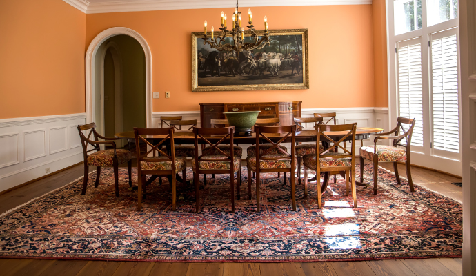 a beautifully decorated room featuring an antique rug