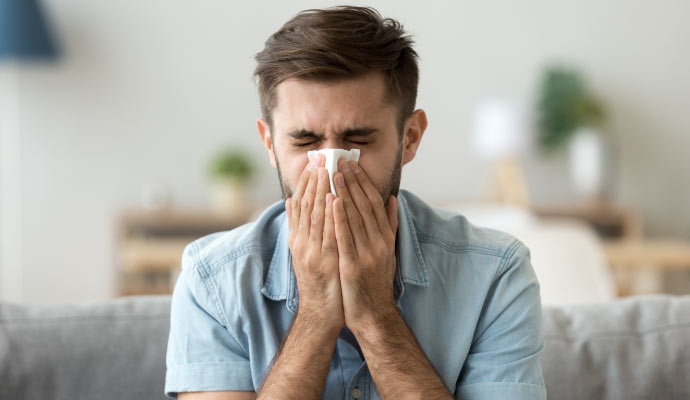 an infected person sneezing