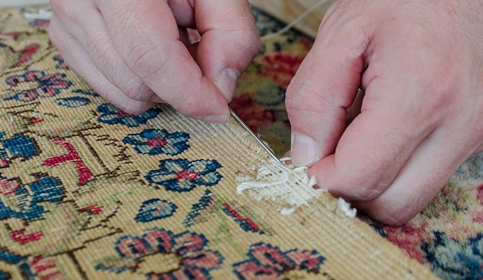 Professional worker fixing rug edge